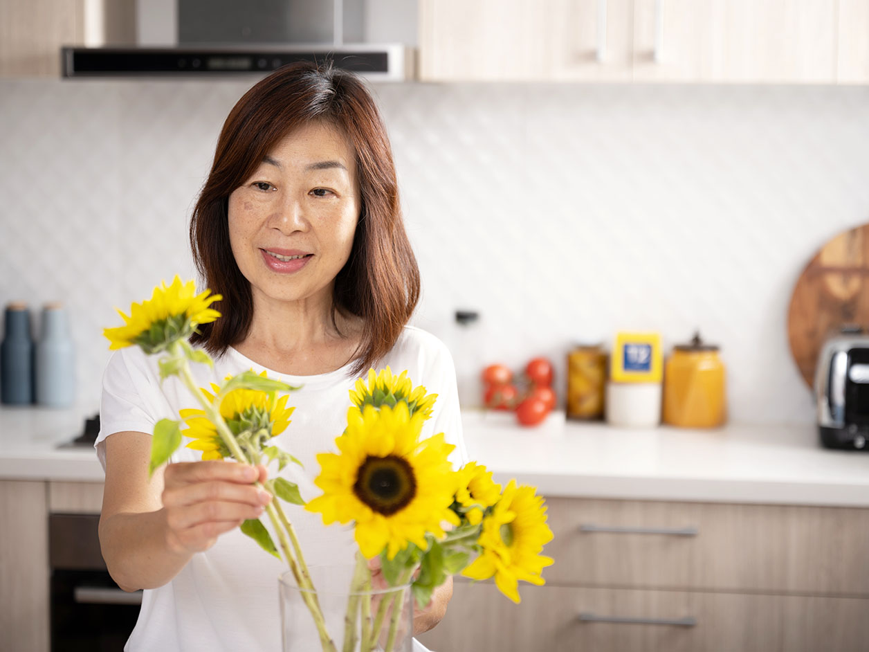 senior-asian-woman-and-sunflower