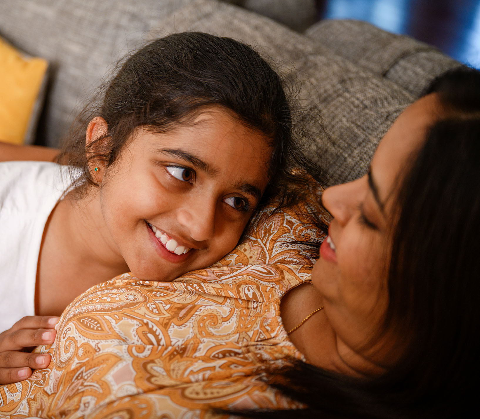 daughter-looking-up-at-mum-on-couch