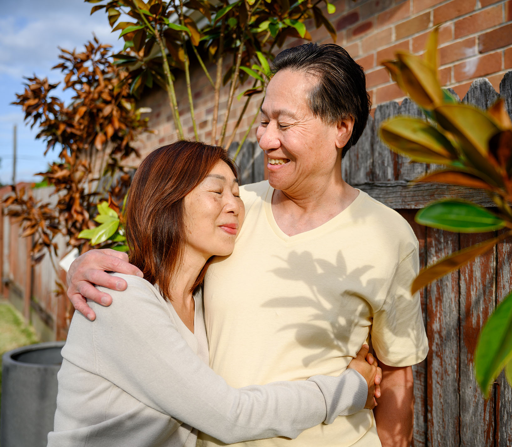 mature-asian-couple-embracing-outdoors