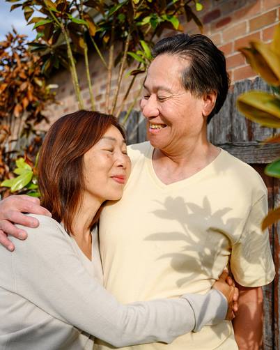 mature-asian-couple-embracing-outdoors