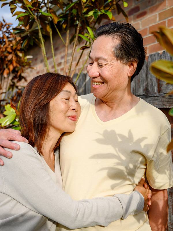 mature-asian-couple-embracing-outdoors